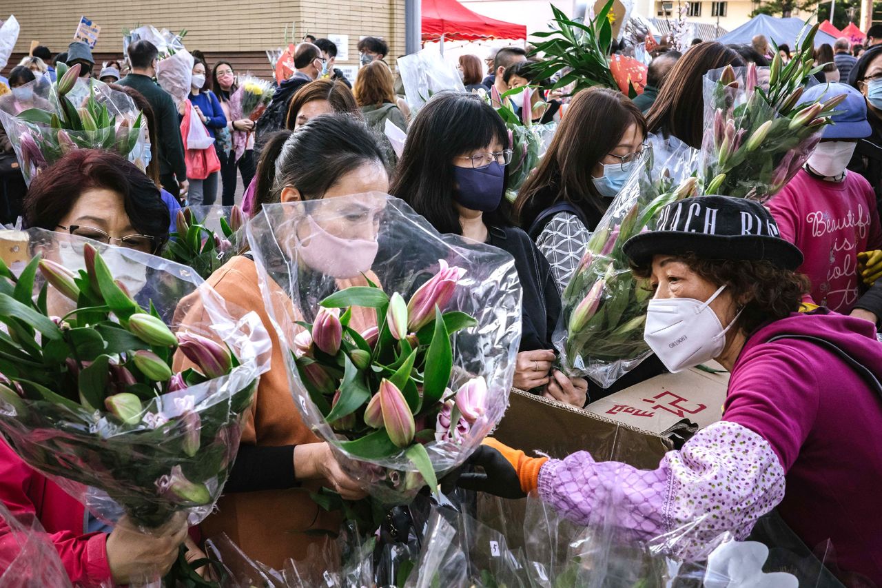 Shoppers purchase flowers at a market in Hong Kong on January 20. The Lunar New Year is also known as the Spring Festival.