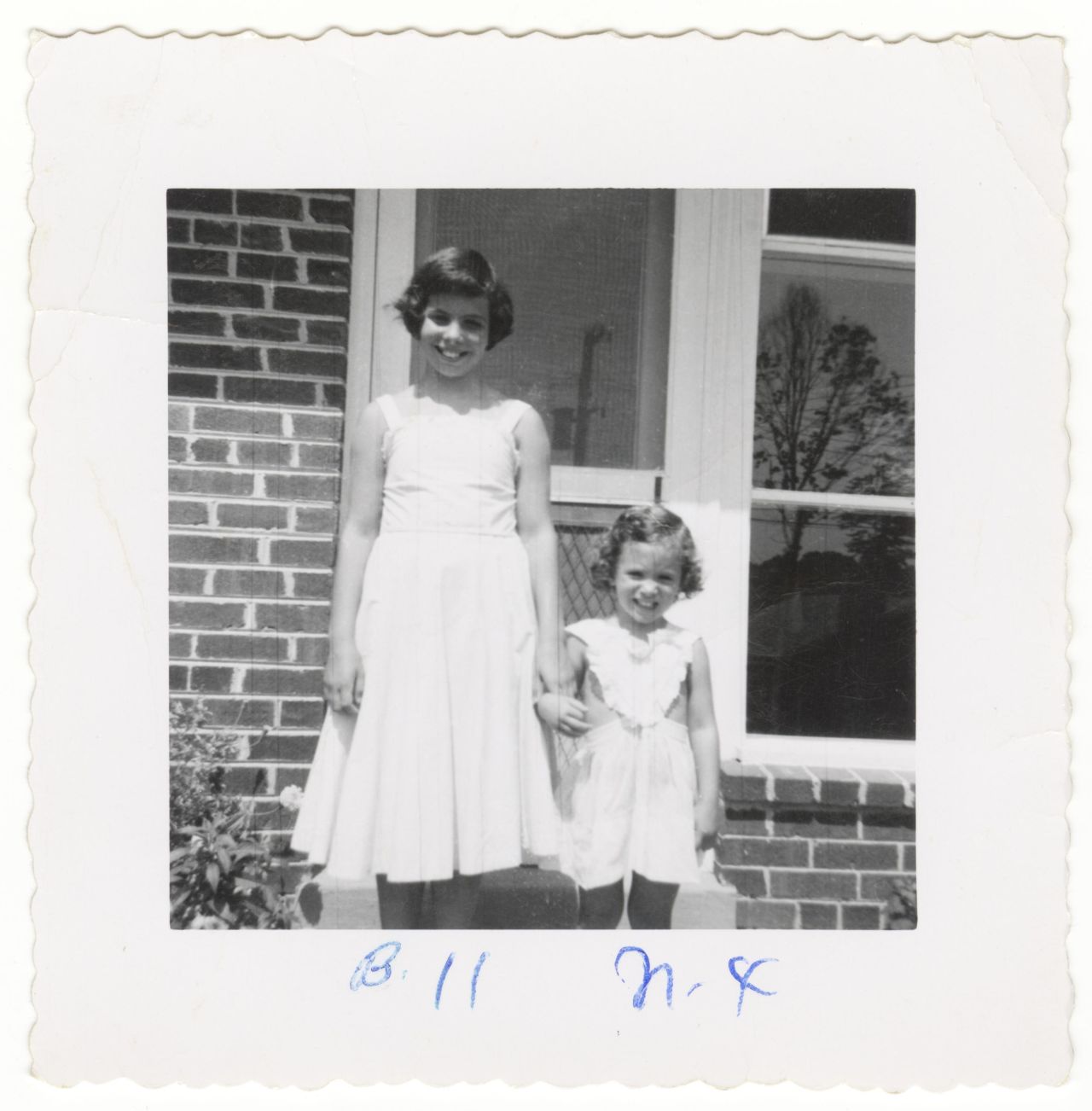 Nan Goldin (right) and her sister, Barbara, holding hands.
