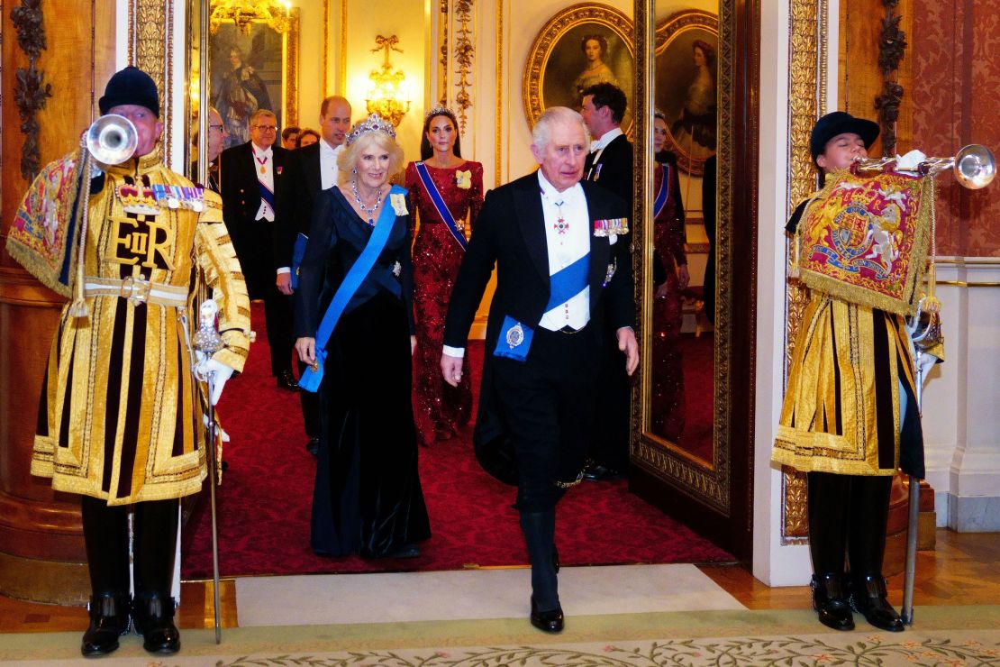King Charles III and the Queen Consort attend a reception at Buckingham Palace on December 6.