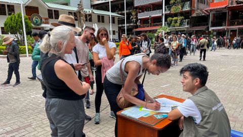 Tourists queue to sign a petition to the railroad company to be evacuated on a "humanitary train" in Machu Picchu, Peru, on January 20, 2023.