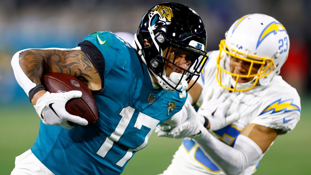 Evan Engram of the Jacksonville Jaguars carries the ball against the Los Angeles Chargers during the second half of the game in the AFC Wild Card playoff game on January 14, 2023.
