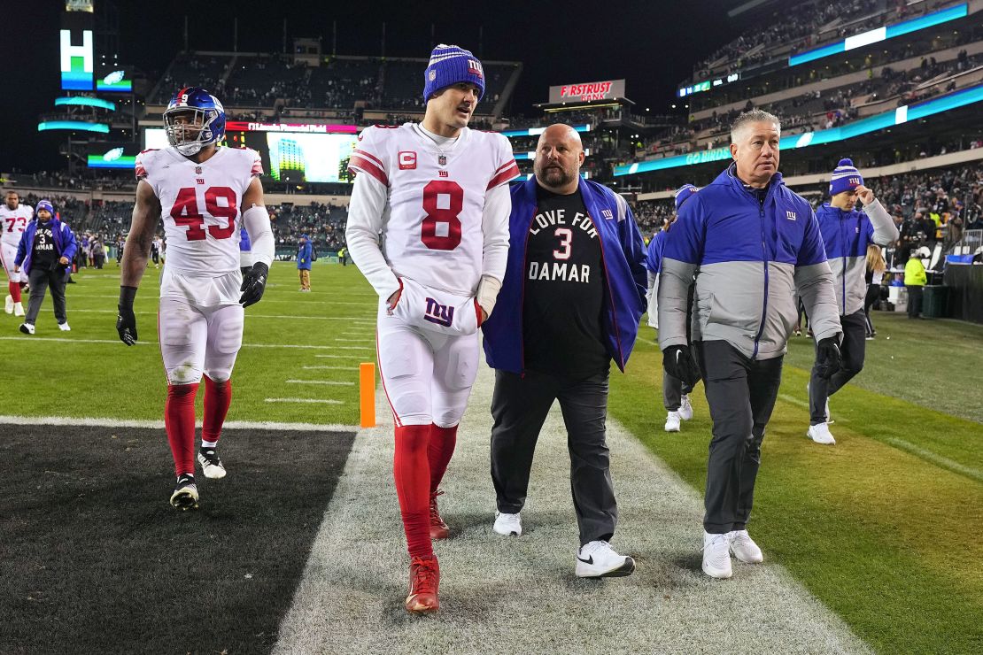Daniel Jones and head coach Brian Daboll of the New York Giants walk off the field on January 8, 2023.