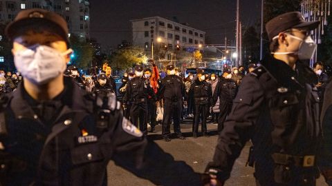 Police officers stand guard during a protest in Beijing, China, on Sunday, November 27, 2022. 