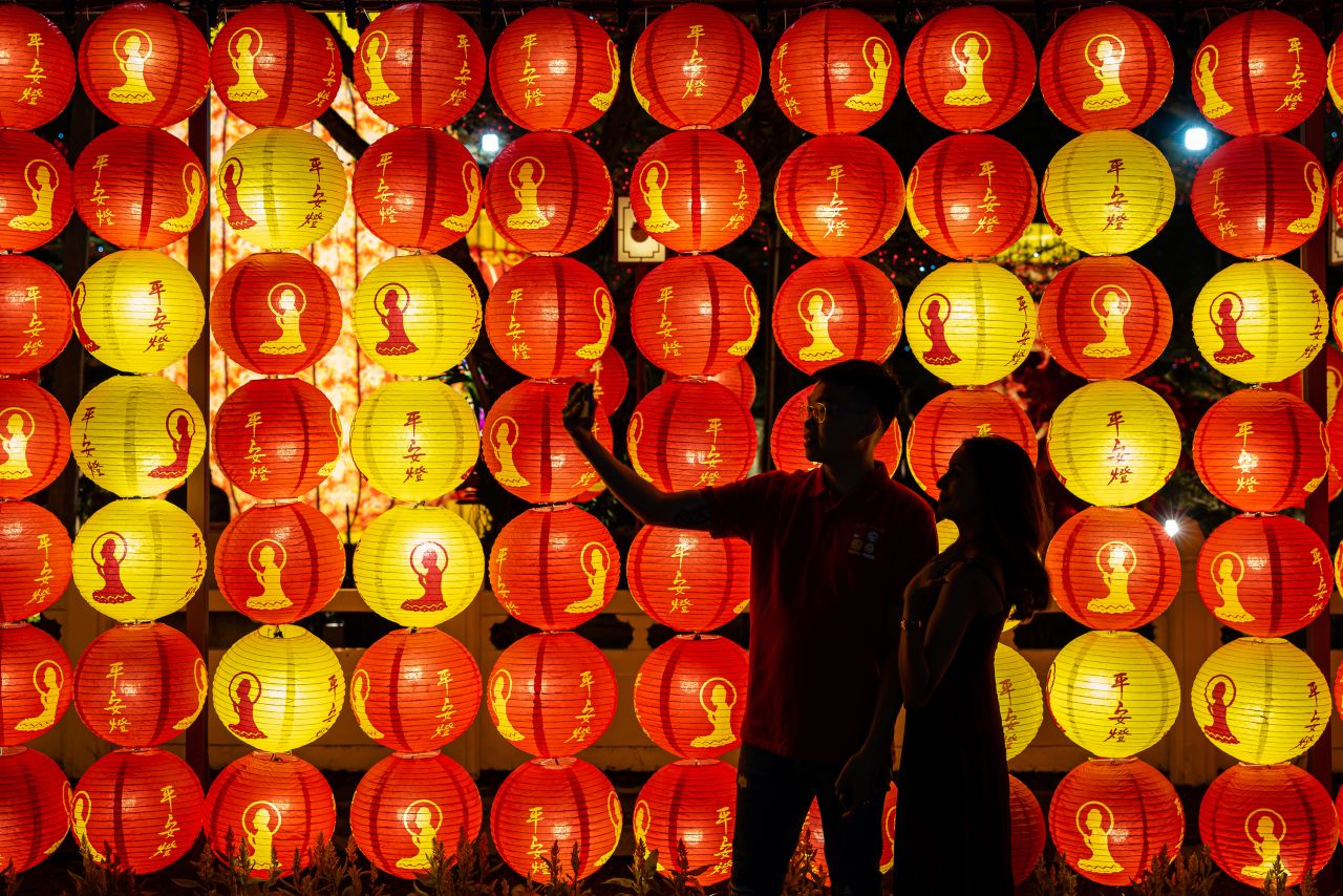 A couple take a selfie in front of lanterns decoration at Fo Guang Shan Dong Zen Buddhist Temple on January 21, in Jenjarom, Selangor, Malaysia. 