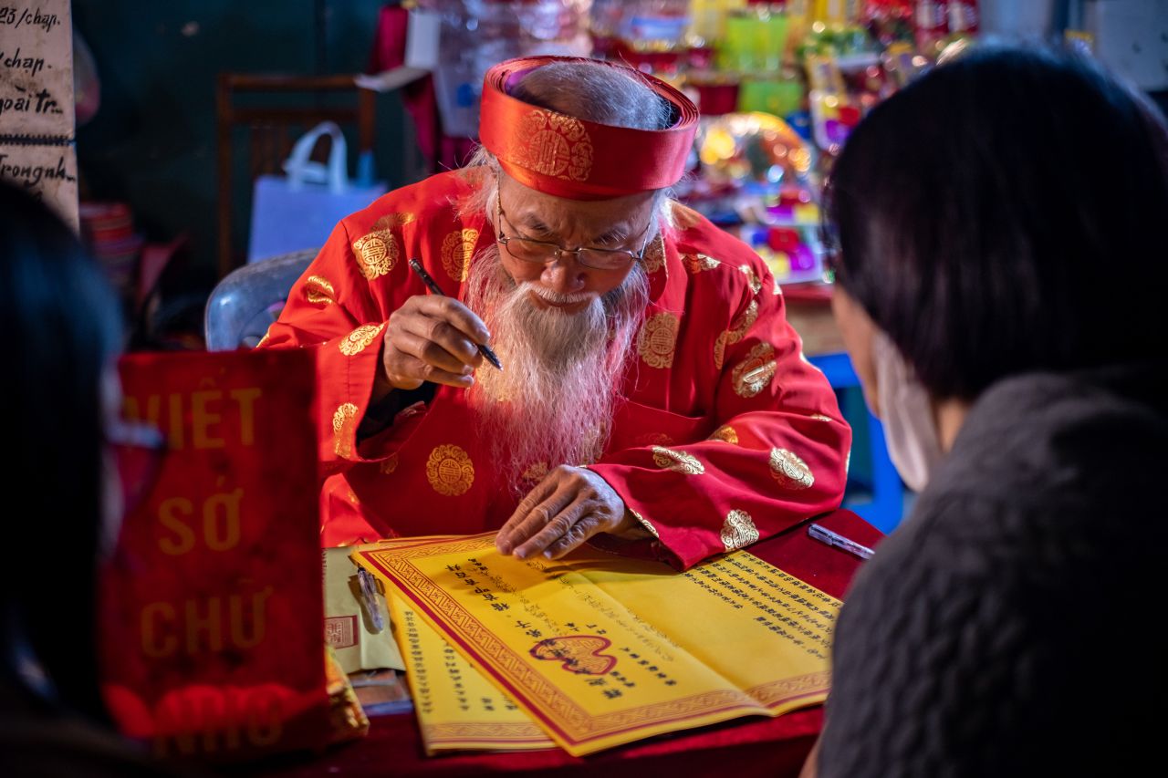A calligrapher writes down wishes to visitors to mark the start of the Lunar New Year on January 22, in Hanoi, Vietnam. 