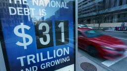 A sign at a bus shelter shows the national debt in Washington, DC on January 20, 2023. - The US Treasury said it began taking measures Thursday to prevent a default on government debt as theÊcountry hit its borrowing limit. (Photo by Mandel NGAN / AFP) (Photo by MANDEL NGAN/AFP via Getty Images)