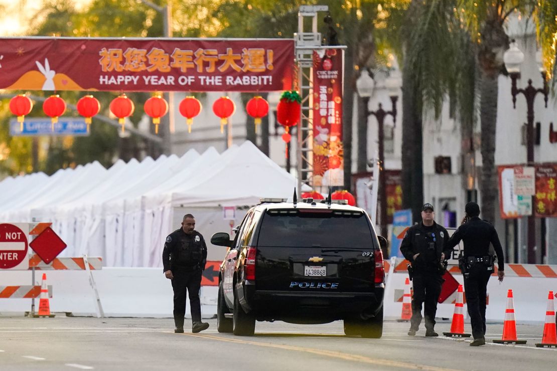 Police officers stand outside a ballroom dance club in Monterey Park. 