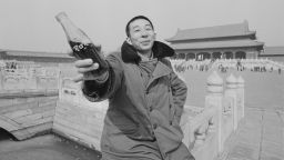 A man holds a Coca-Cola bottle outside the Forbidden City in 1981. 