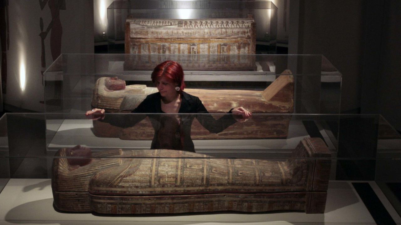 A National Museum of Scotland staff member looks at a collection of ancient Egyptian remains. The museum is rethinking its use of the word 'mummy' in displays. 