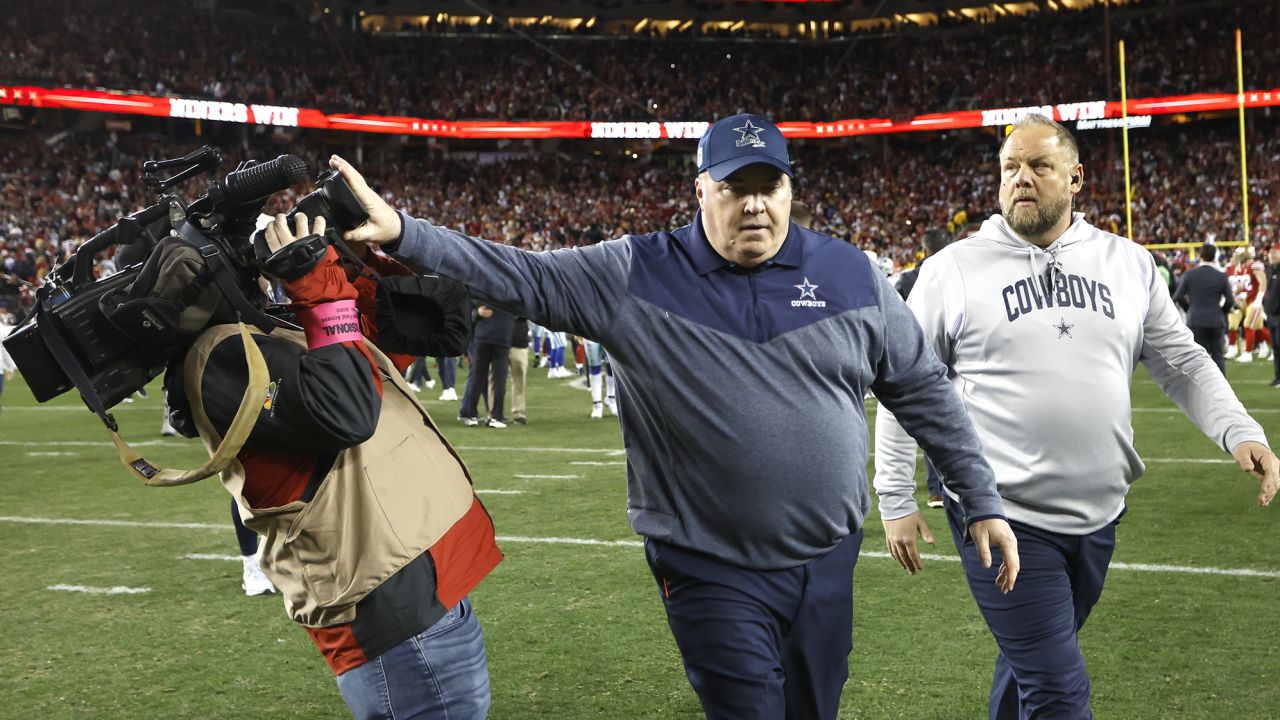 Dallas Cowboys head coach Mike McCarthy pushes a cameraman away while walking off the field after losing to the San Francisco 49ers.