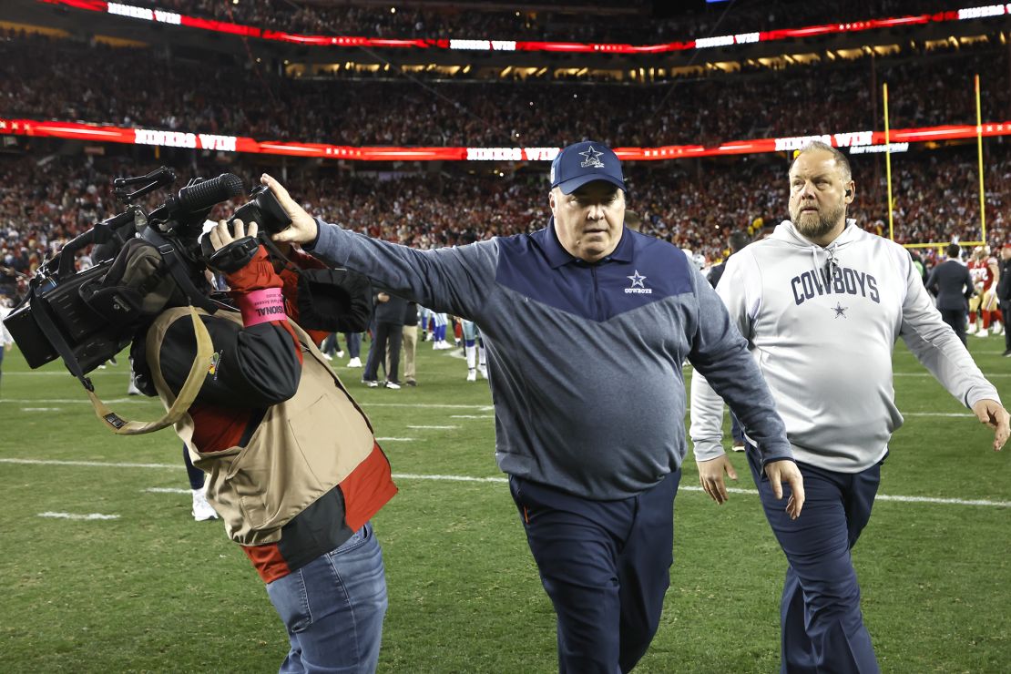 Dallas Cowboys head coach Mike McCarthy pushes a cameraman away while walking off the field after losing to the San Francisco 49ers.