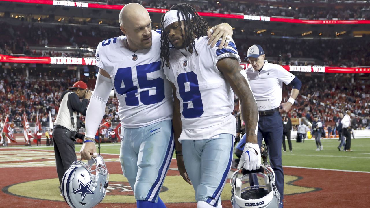 Dallas Cowboys long snapper Matt Overton consoles wide receiver KaVontae Turpin after the defeat to the 49ers.