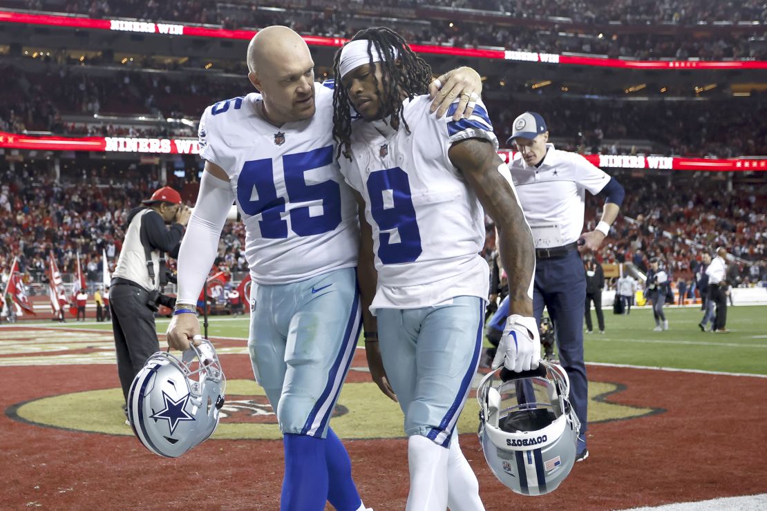 Dallas Cowboys long snapper Matt Overton consoles wide receiver KaVontae Turpin after the defeat to the 49ers.