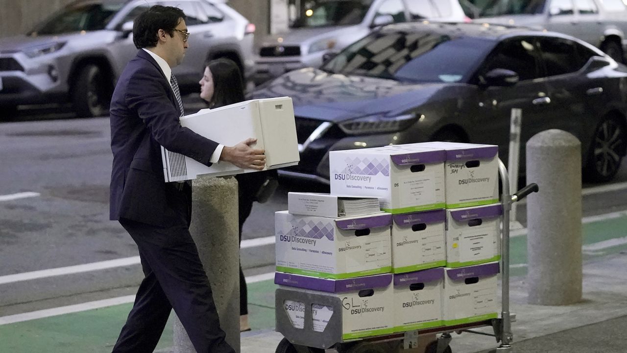 Documents related to the class-action lawsuit on behalf of investors who owned Tesla stock in August 2018 are loaded onto a cart outside of a federal courthouse in San Francisco, Tuesday, Jan. 17, 2023.