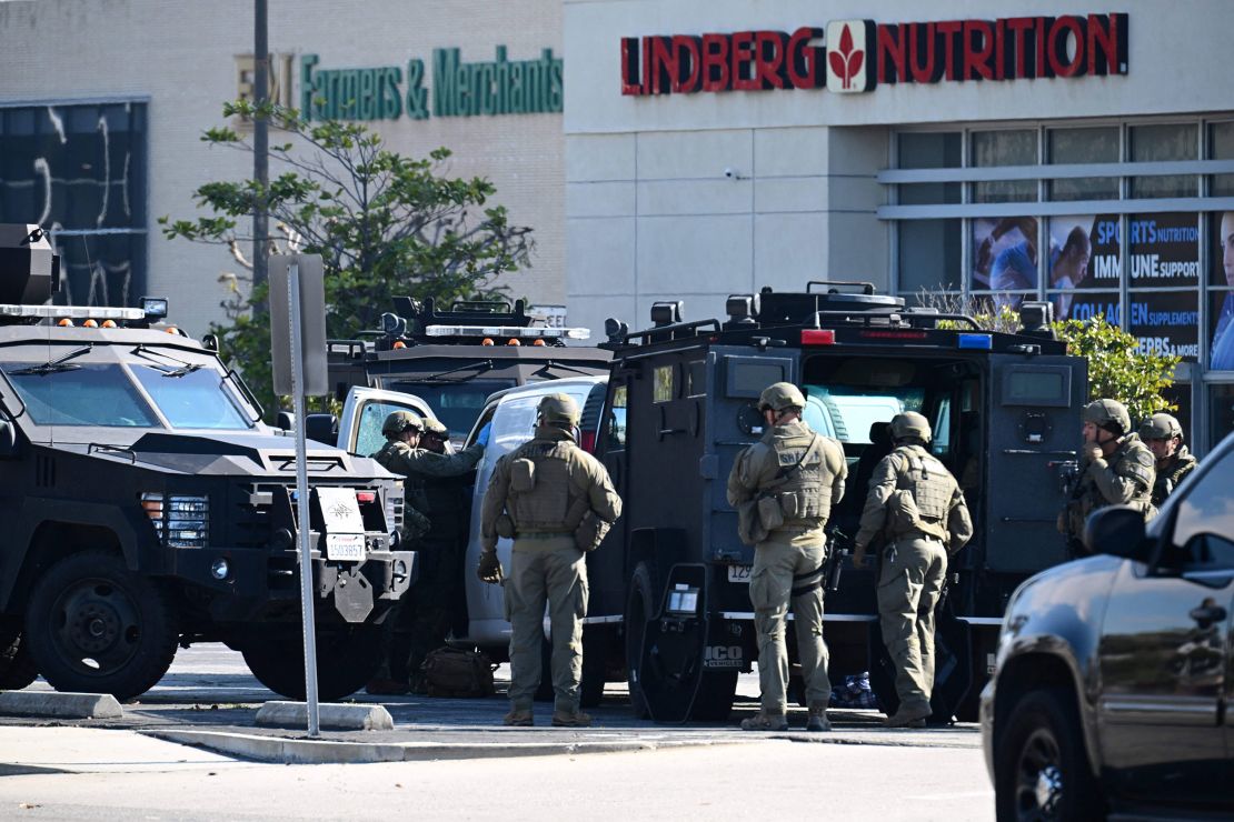 Law enforcement personnel open the door of a van driven by the suspect, in Torrance, California.
