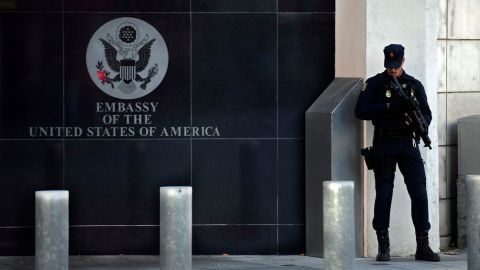 A Spanish policeman stands guard near the US embassy in Madrid, on December 1, 2022, after they have received a letter bomb, similar to one which went off at the Ukrainian embassy. 