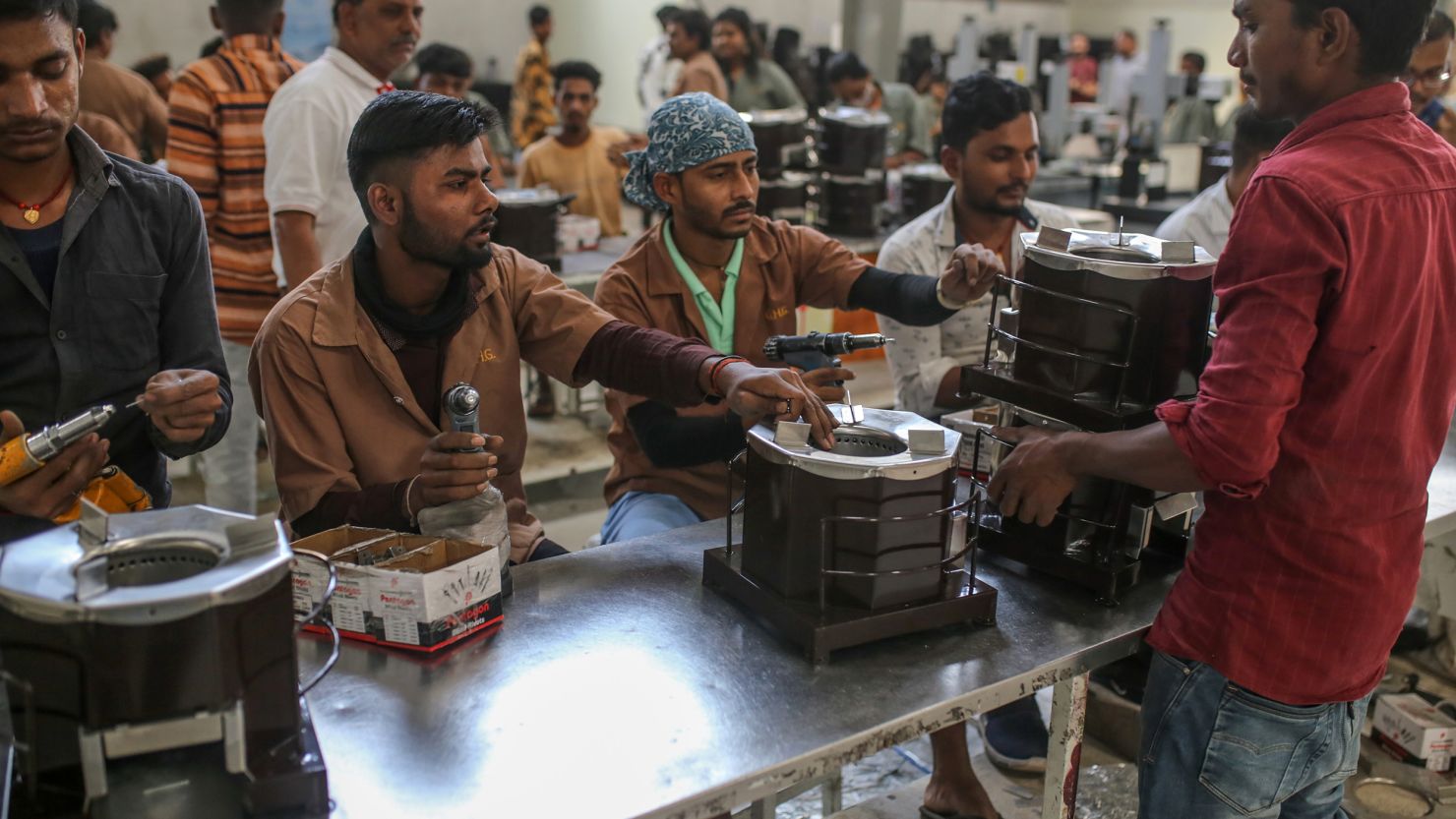 Workers assemble cookstove parts at a manufacturing plant in Nashik, India, in November. 