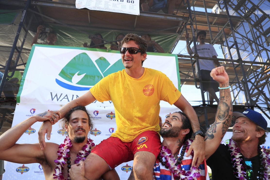 Luke Shepardson is congratulated by fellow surfers Landon McNamara (left) and Billy Kemper after winning the Eddie Aikau Big Wave Invitational at Waimea Bay.
