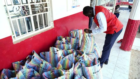 A member of the Gambia Red Cross looks through sacks of collected cough syrups in Banjul, the country's capital.