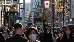Japanese flags adorn a popular street in the shopping district of Ginza in Tokyo on December 29, 2022.