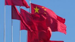 Chinese national flags and the red flags are streamed in the wind on the rooftop at Great Hall of the People in Beijing, China on January 2, 2023.