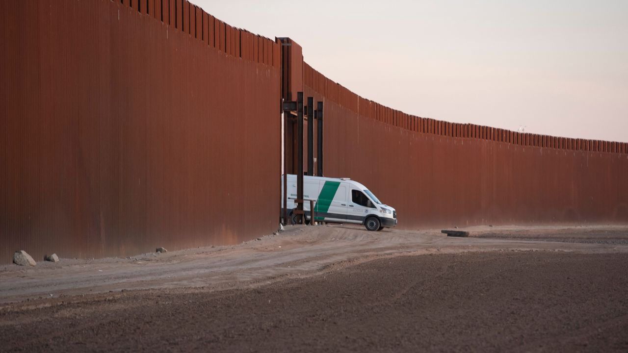 A Border Patrol van reverses through a gate in the US-Mexico border fence in San Luis, Arizona, on December 26, 2022.