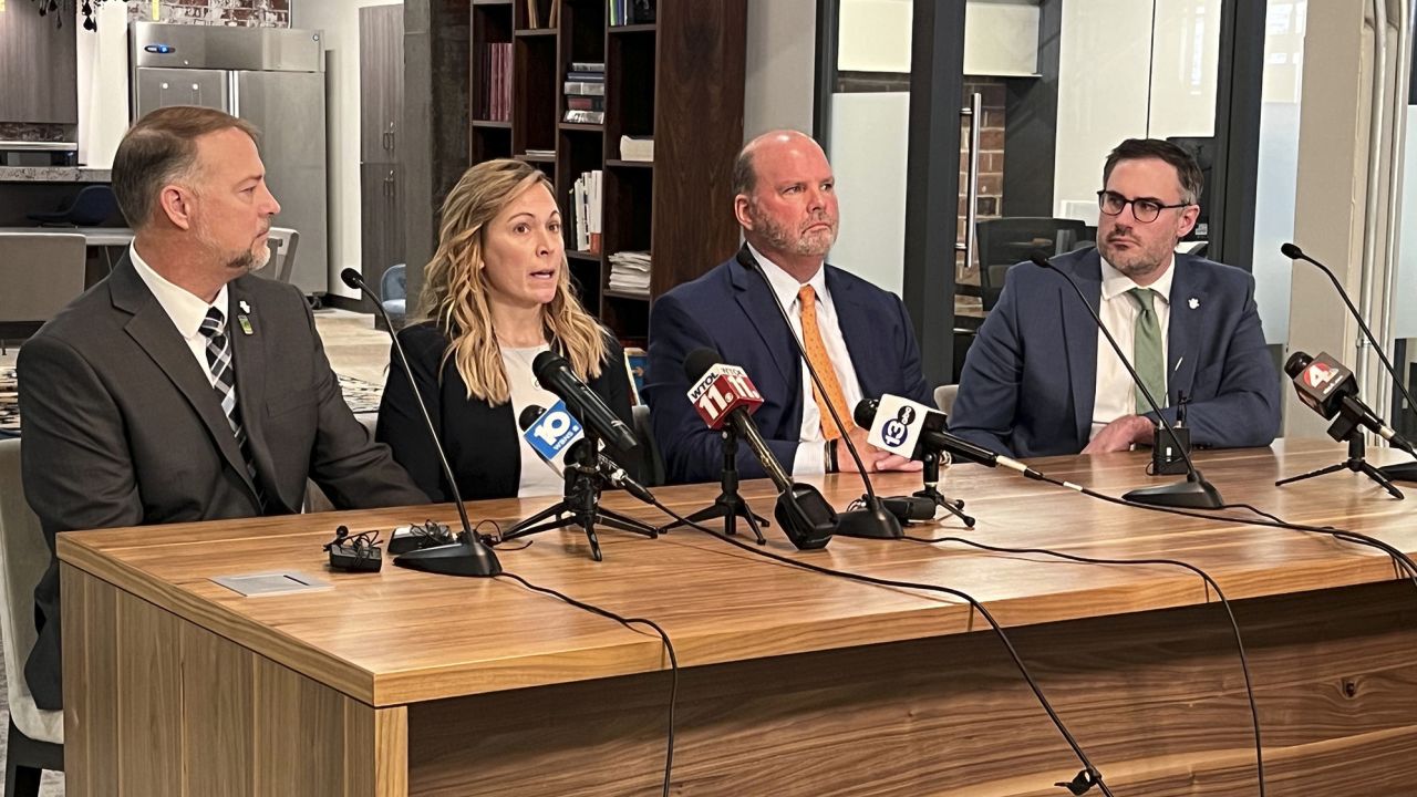 Shari Foltz, second left, speaks while she and her husband Cory Foltz, left, sit next to attorneys during a news conference on Monday.