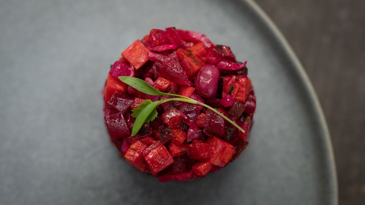 The Better Vinaigrette Salad is packed with complex carbohydrates like navy beans, peas, carrots, sweet potatoes and beets. Click through to see more dishes from Dan Buettner's new cookbook.