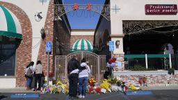 People stand near a memorial outside the Star Ballroom Dance Studio on Tuesday, Jan. 24, 2023, in Monterey Park, Calif. A gunman killed multiple people at the ballroom dance studio late Saturday amid Lunar New Years celebrations in the predominantly Asian American community. 
