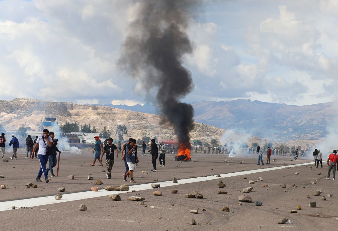 Demonstrators stand on an airport tarmac amid violent protests in Ayacucho, Peru December 15, 2022. 