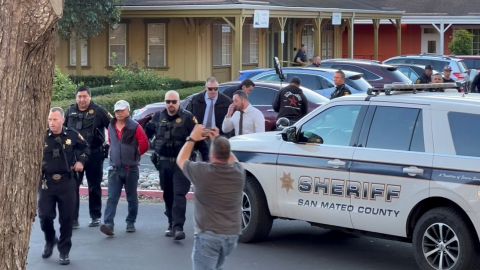 In this screen grab from a social media video, police officers take a suspect into custody after a shooting in Half Moon Bay, Calif., on Monday. 