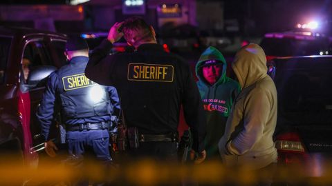 Sheriff's deputies talk with people at the scene of a deadly shooting in Half Moon Bay Monday.