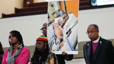 Family members and supporters hold up a photo of Tire Nichols at a news conference in Memphis, Tenn. on Monday.