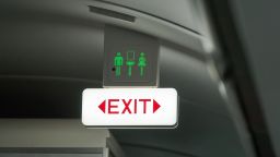 Exit seat belt and toilet sign on a flight.