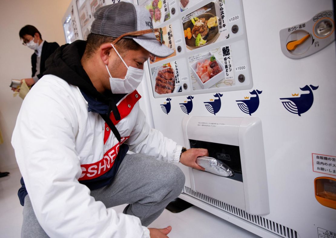 A customer buys whale meat from a vending machine in Yokohama, Japan, on January 24.