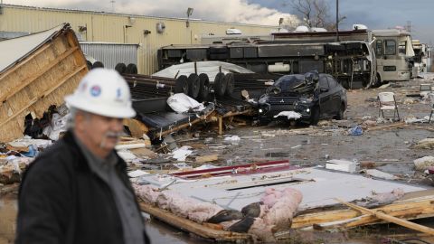 Johnny Graham walks past his storm-damaged office on Tuesday in Pasadena, Texas. 