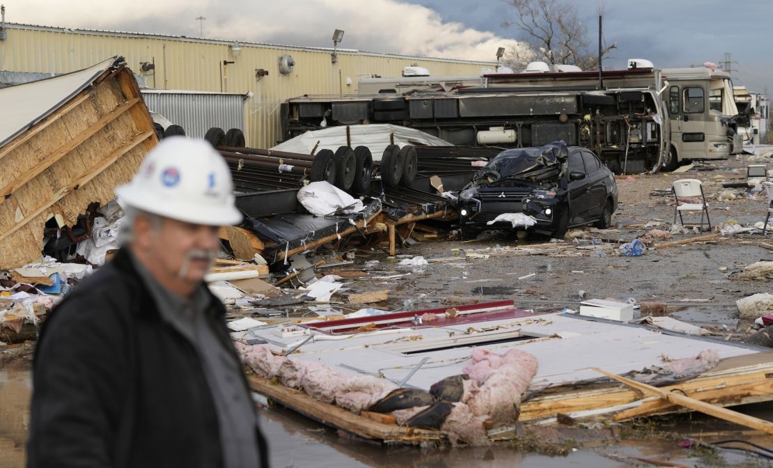 Johnny Graham walks past his storm-damaged office on Tuesday in Pasadena, Texas. 