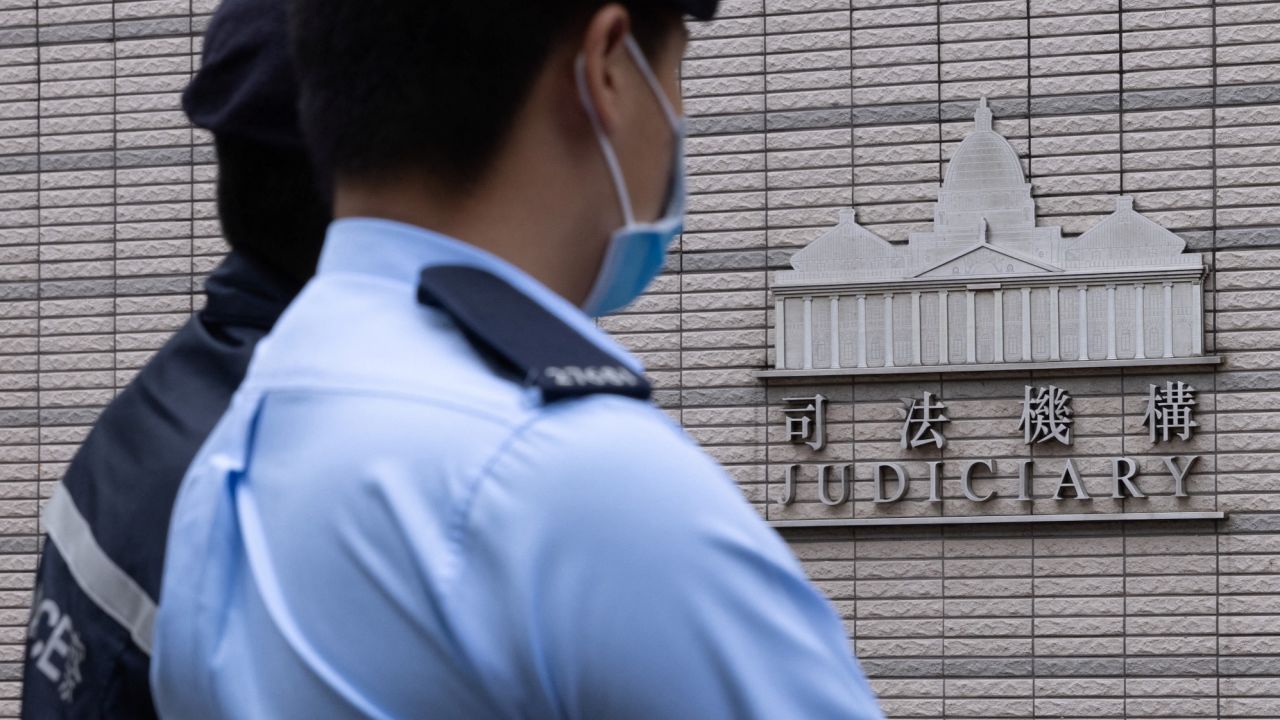 Police stand guard outside the West Kowloon Magistrates' courts in Hong Kong on November 25, 2022.