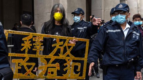 Activist Leung Kwok-hung holds a placard that says "free political prisoners" outside the Court of Final Appeal on February 9, 2021. 