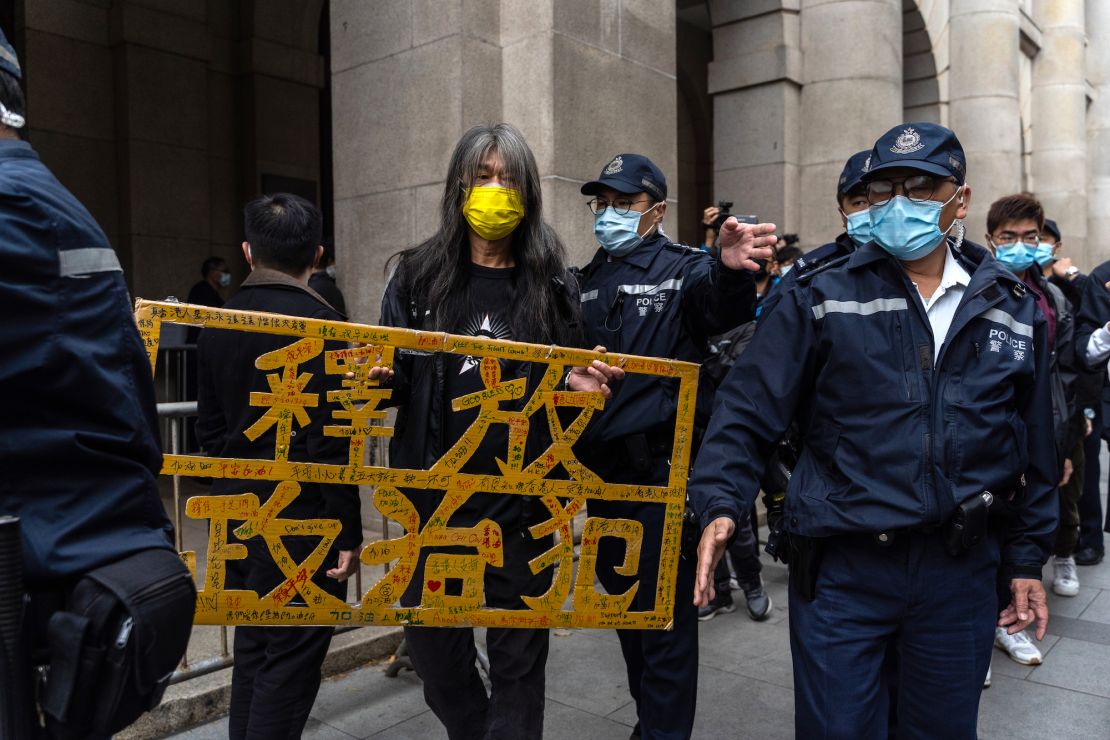 Activist Leung Kwok-hung holds a placard that says "free political prisoners" outside the Court of Final Appeal on February 9, 2021. 