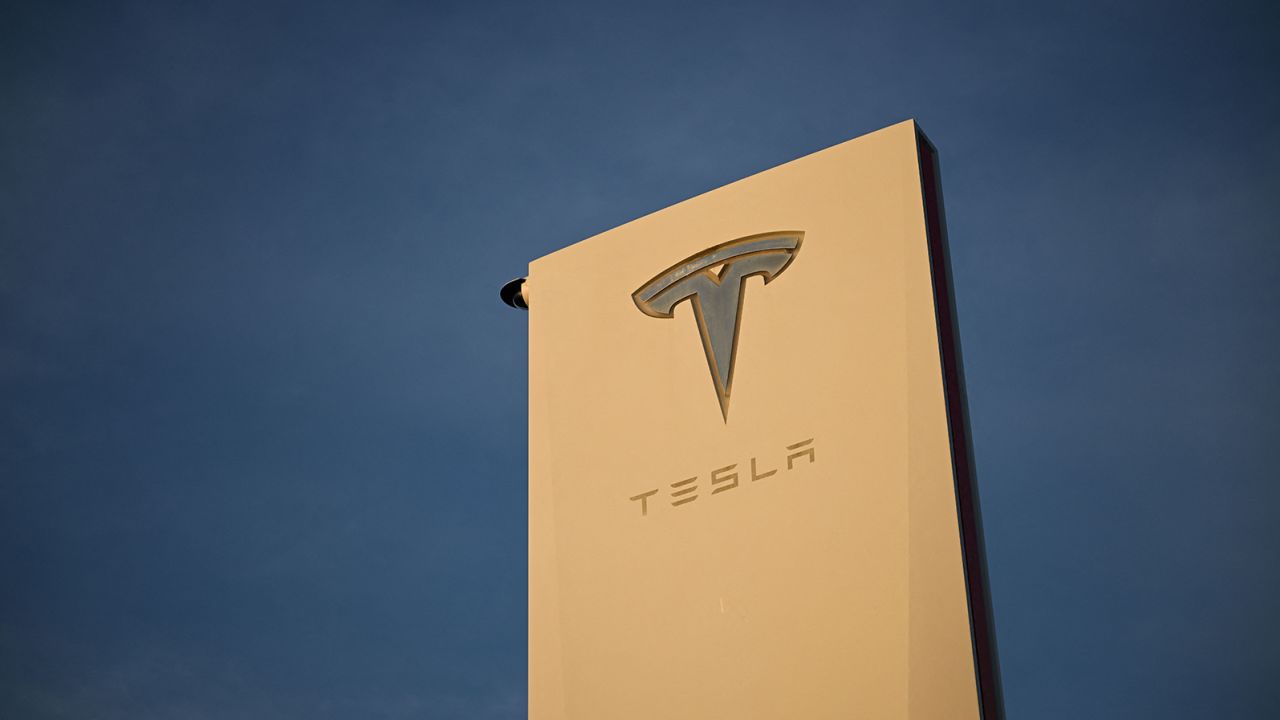 The Tesla, Inc. logo is displayed on a sign outside the Tesla Design Center in Hawthorne, California, on August 9, 2022. 