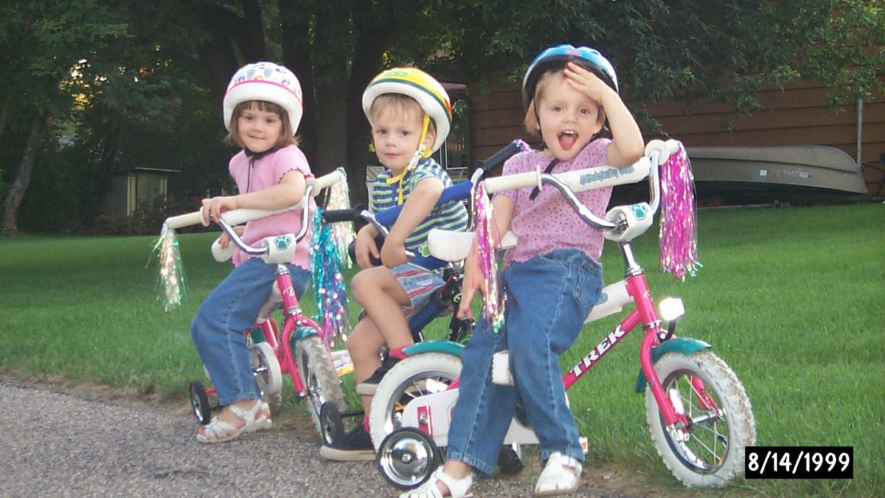Kelly, along with her siblings Colin and Christine, pictured as a child on a bike ride in Minneapolis. Cycling was a passion from an early age, according to her father. 