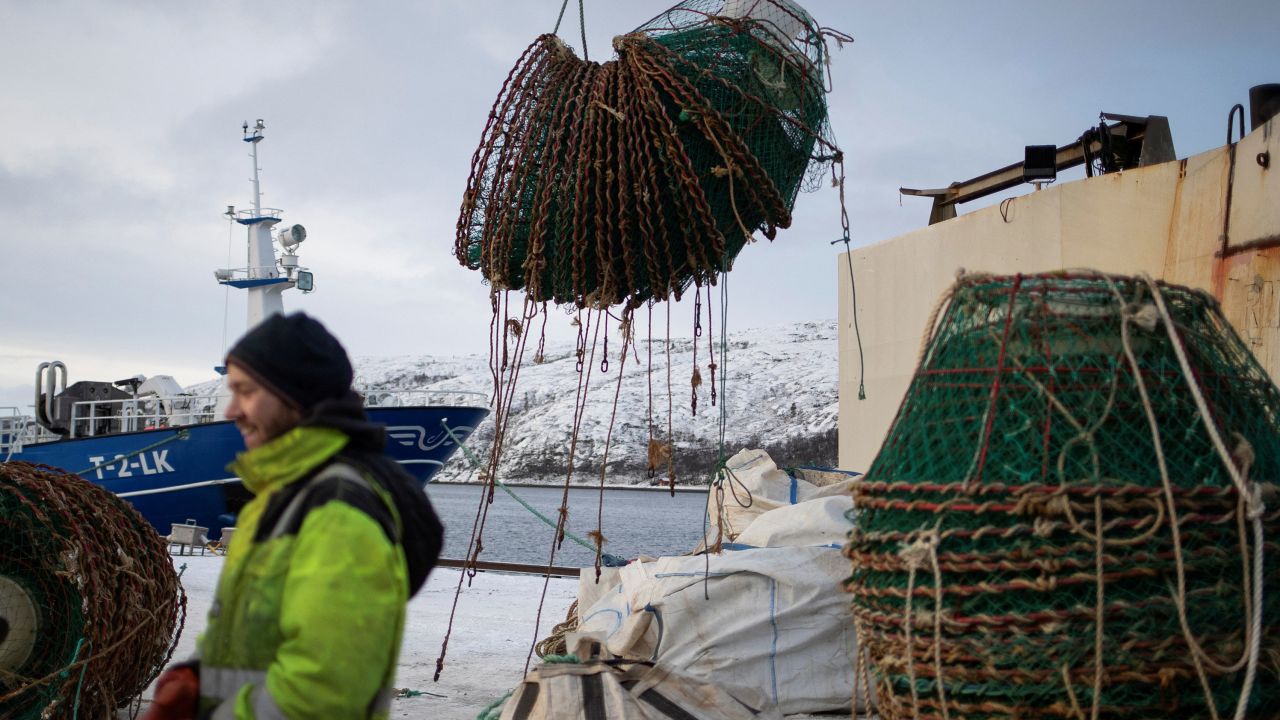 A sailor prepares to offload fishing equipment from a snow crab fishing vessel in Kirkenes, Norway.
