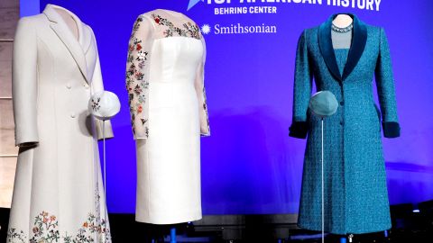 Both of First Lady Jill Biden's 2021 inaugural ensembles wait onstage for an event where Biden will donate them to the Smithsonian's National Museum of American History in Washington on January 25. 
