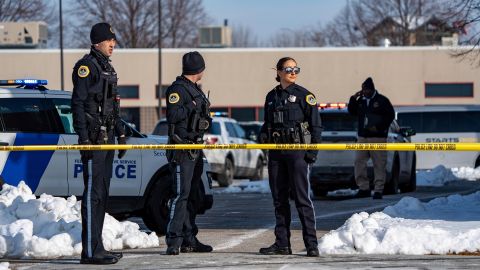 Officials stand outside an education program building after a shooting in Des Moines, Iowa, on Monday.  