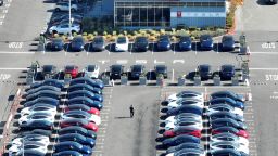 In an aerial view, brand new Tesla cars sit in a parking lot at the Tesla factory on October 19, 2022 in Fremont, California. 