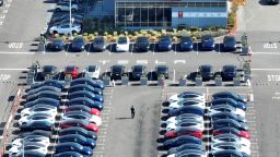 In an aerial view, brand new Tesla cars sit in a parking lot at the Tesla factory on October 19, 2022 in Fremont, California.