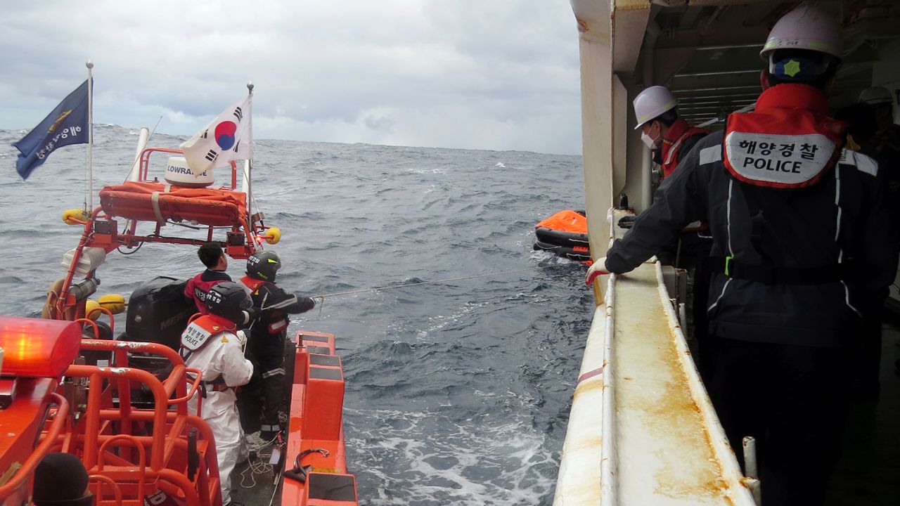 Members of South Korea's coast guard search for the missing crew in waters between South Korea and Japan on January 25.