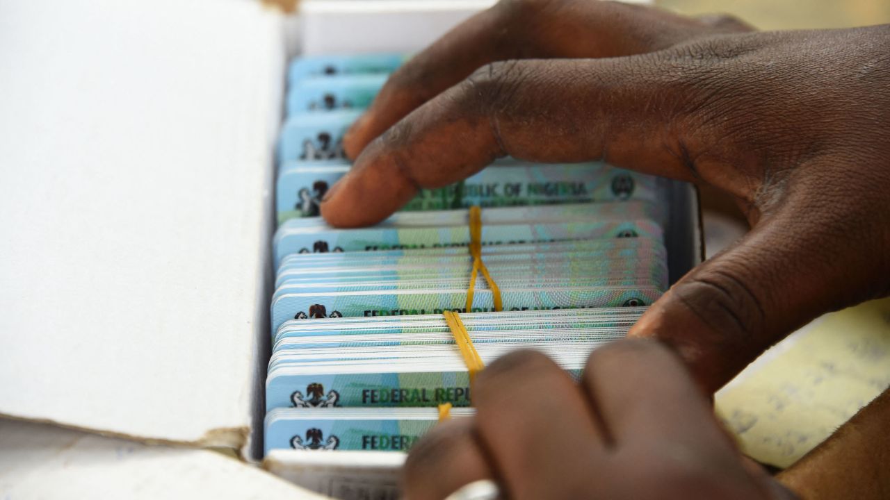 An official of the Independent National Electoral Commission (INEC) sort out Permanent Voters cards (PVC) of voters at a ward in Lagos on January 12, 2023 ahead of February 25 presidential election. 