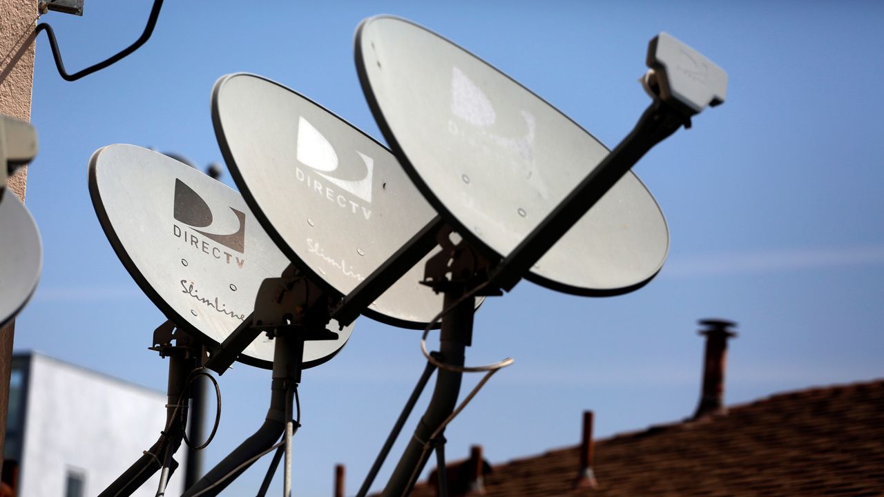 DirecTV satellite dishes are seen on an apartment roof in Los Angeles, California in this file photo taken May 18, 2014. 